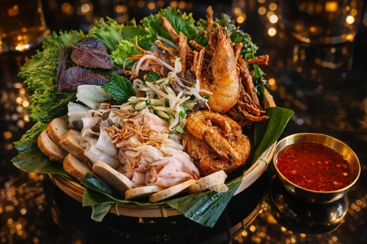 A brunch platter of steamed rice rolls with herbs, shrimp and dipping sauce